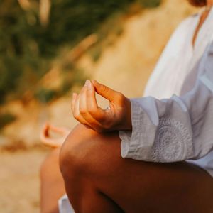 Close-up on hands in a meditative mudra position.